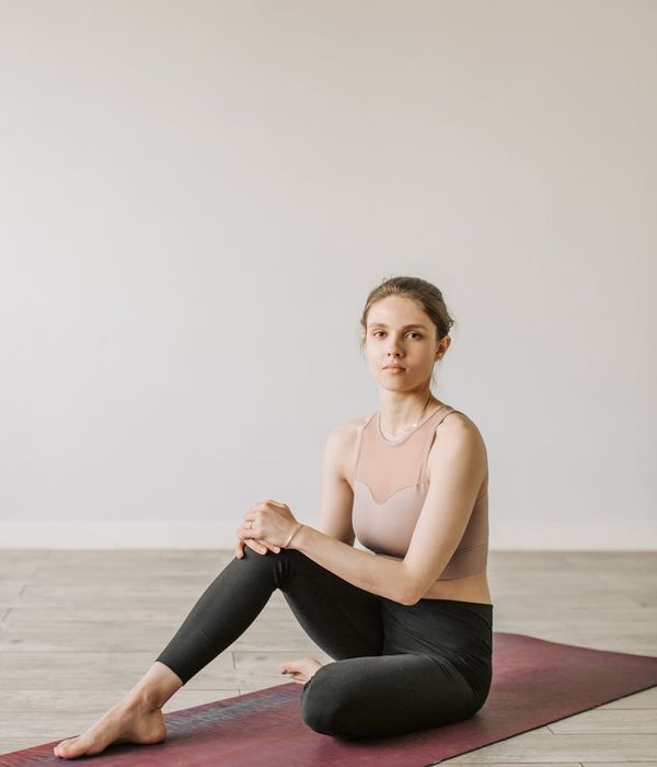 Person practicing gentle yoga in a bright studio environment